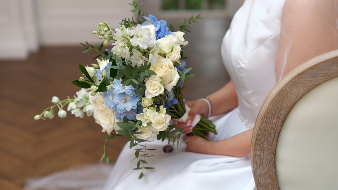The bride's baby-blue bouquet during a candid moment.