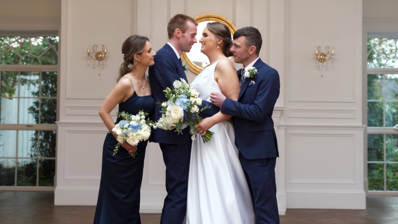 Tracey and Andrew's bridal party posing for photographs in Leighinmohr House's garden room.