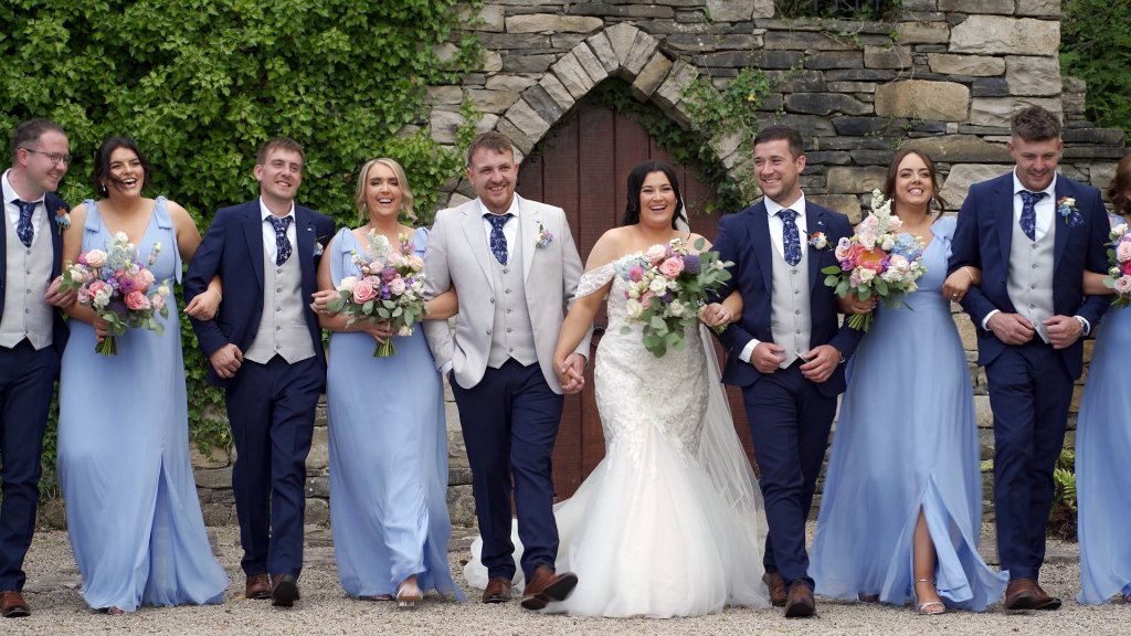 Bride Charlene and Groom Jack walking with bridesmaids in light blue dresses and groomsmen in navy suits at An Grianan Hotel, Donegal.