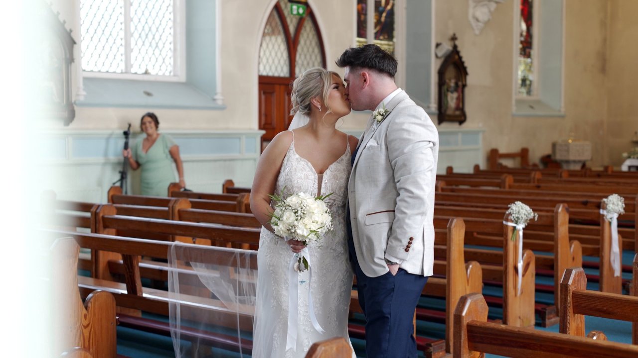 Ciara and Darian sharing a kiss among the pews of St Mary's Church, Buncrana.