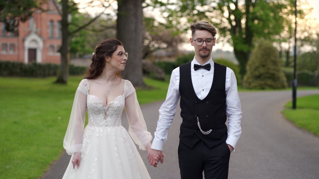 Carolann and Jack walking hand-in-hand along a tree-lined path at Beech Hill Country House.