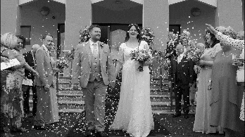 Black and white video of Grace and Christopher walking through a shower of confetti outside Calvary Free Presbyterian Church, Magherafelt.