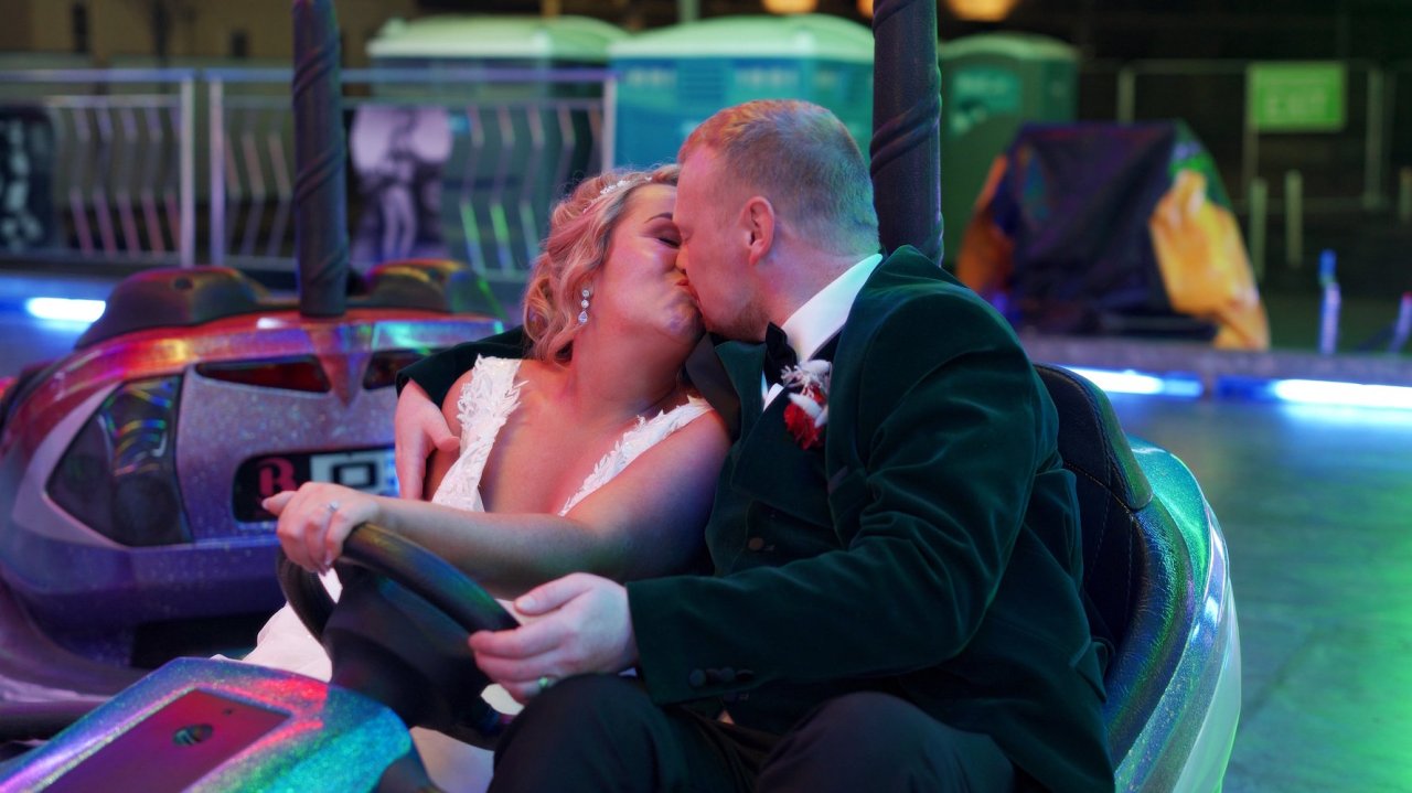 A bride and groom ride in a bumper car at the Halloween Festival in Derry.
