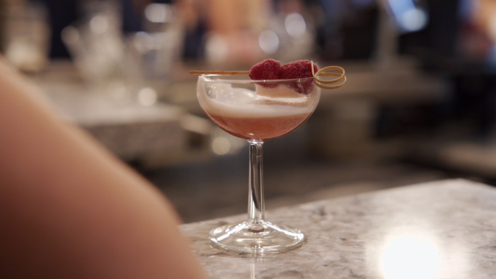 Cinematic close up of a wedding cocktail with raspberry garnish at the Leighinmohr House bar.
