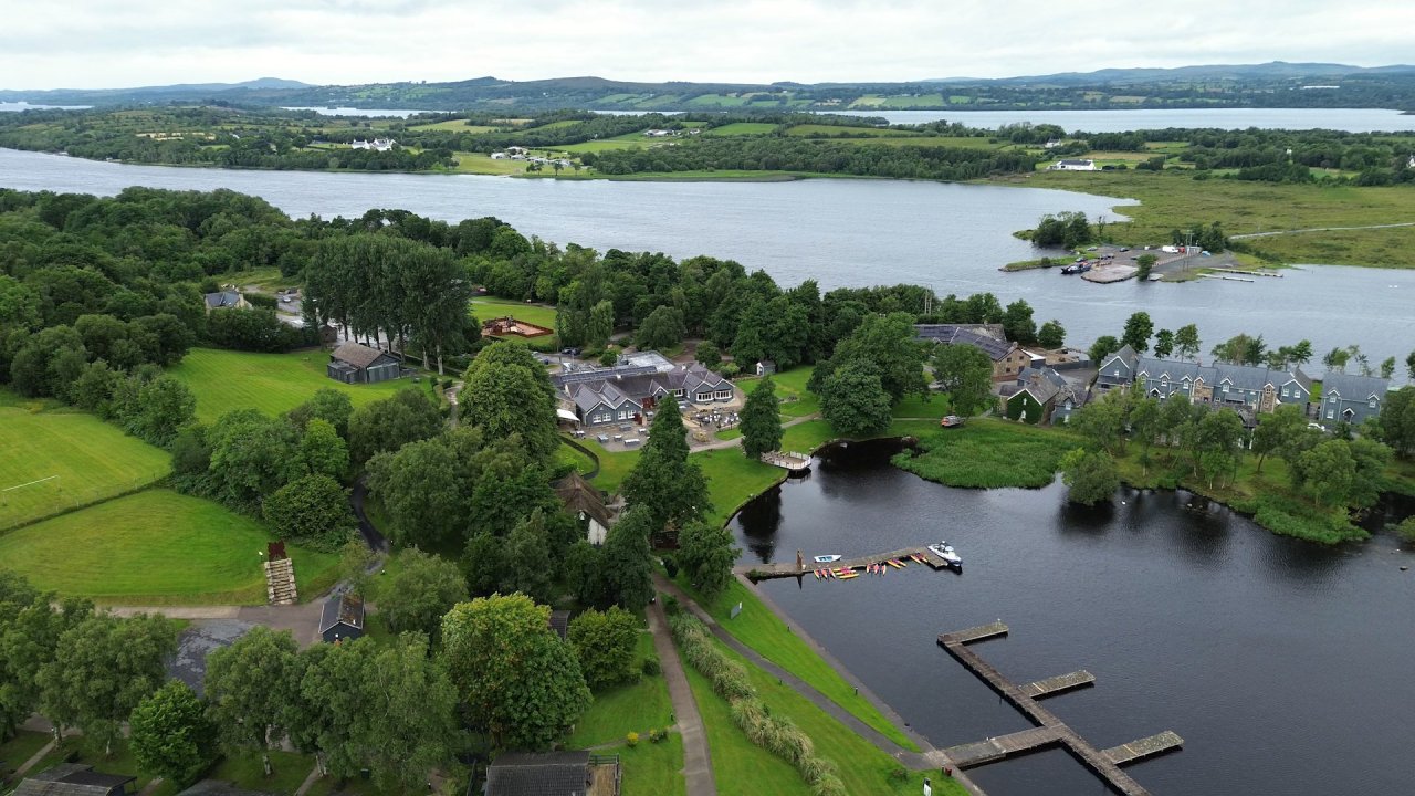 Aerial drone shot of Lusty Beg Resort island surrounded by water and lush greenery.