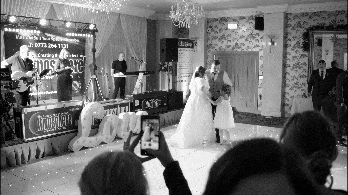 Black and white GIF of Samantha and William’s first dance at Manor House Hotel with a live band.