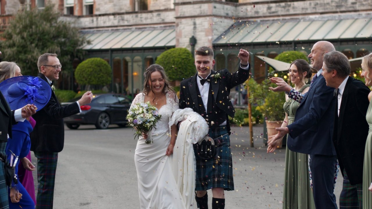 Wedding guests throwing confetti at Amy and Sam outside Magheramorne Estate.