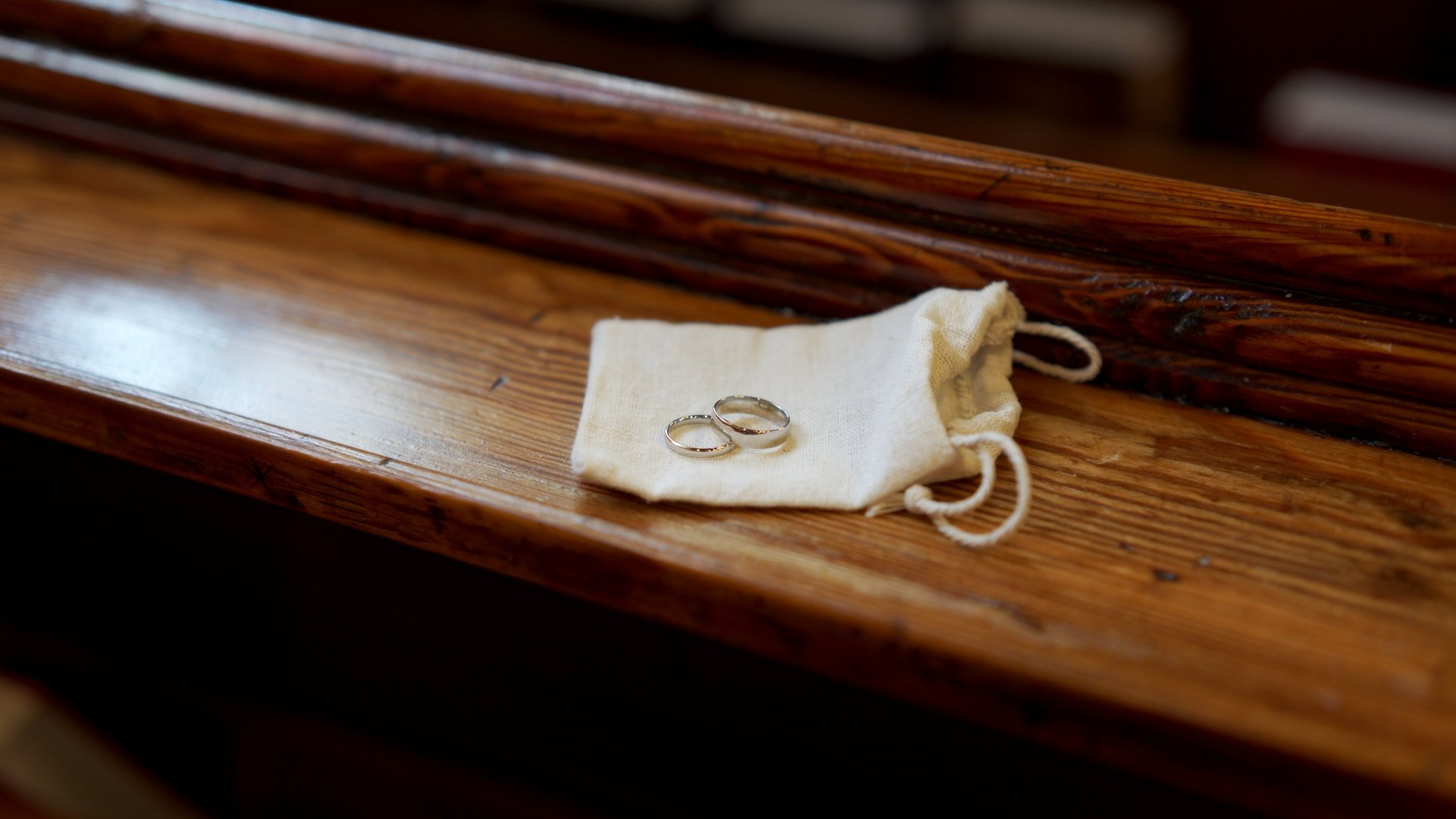 Wedding bands sitting on a small linen pouch at Knock Methodist Church.