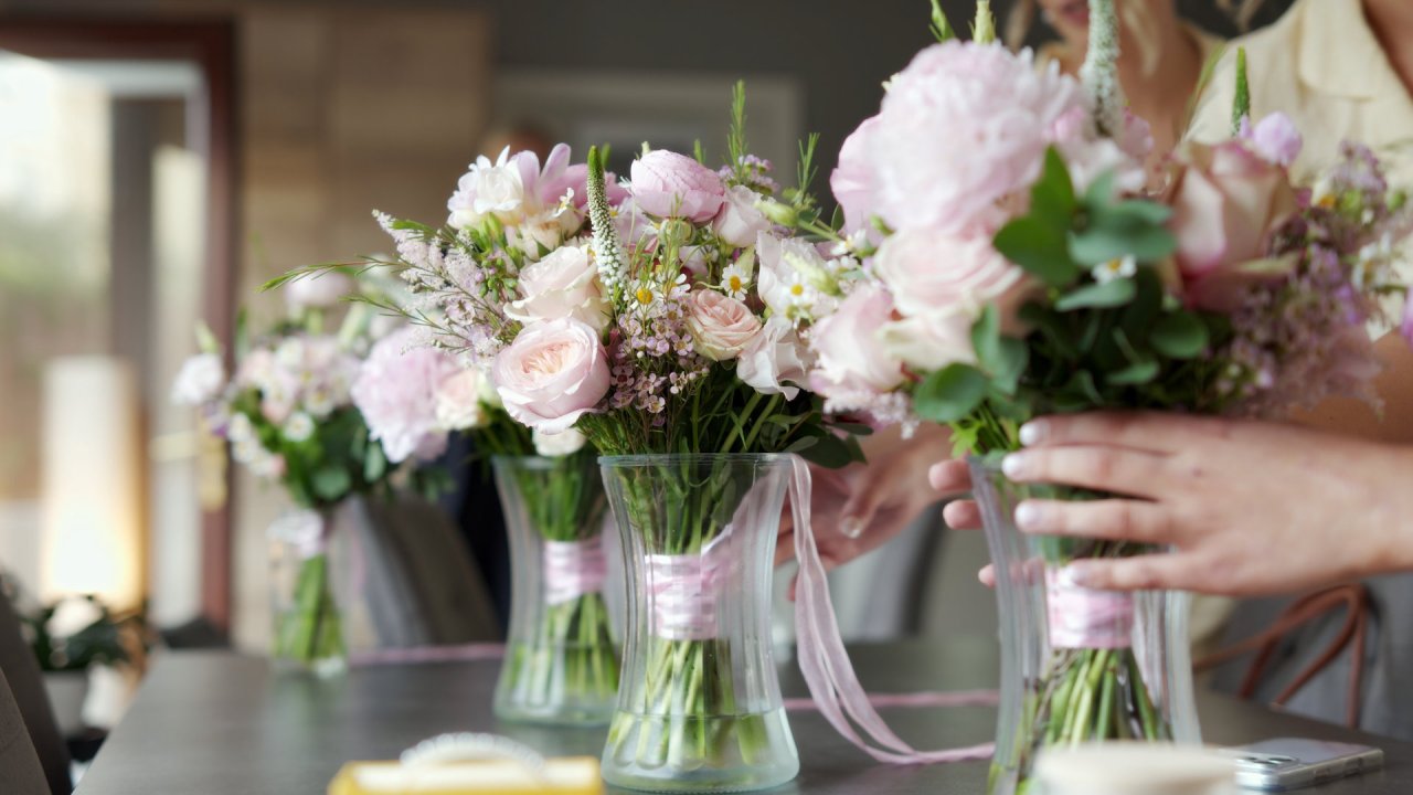 Pink and white floral wedding bouquets in glass vases for the Rainey wedding.