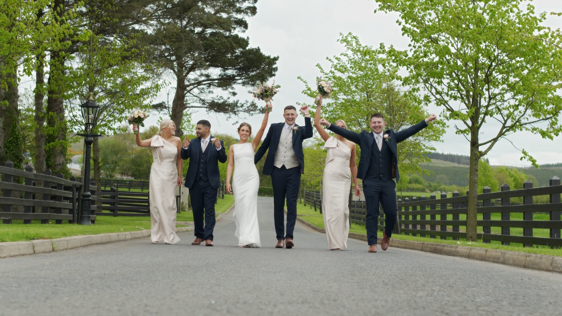 Bride Cliona and groom Callum cheering with their bridal party on the grounds of Ballyness Resort.