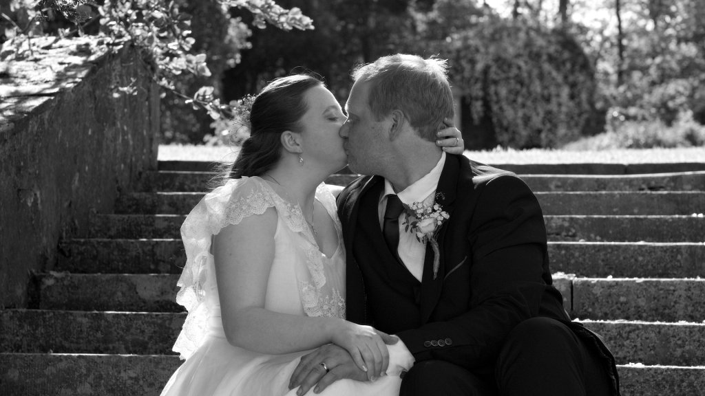 Shauna and Samuel sharing a romantic embrace in the gardens of Greenfort House near the Portsalon.