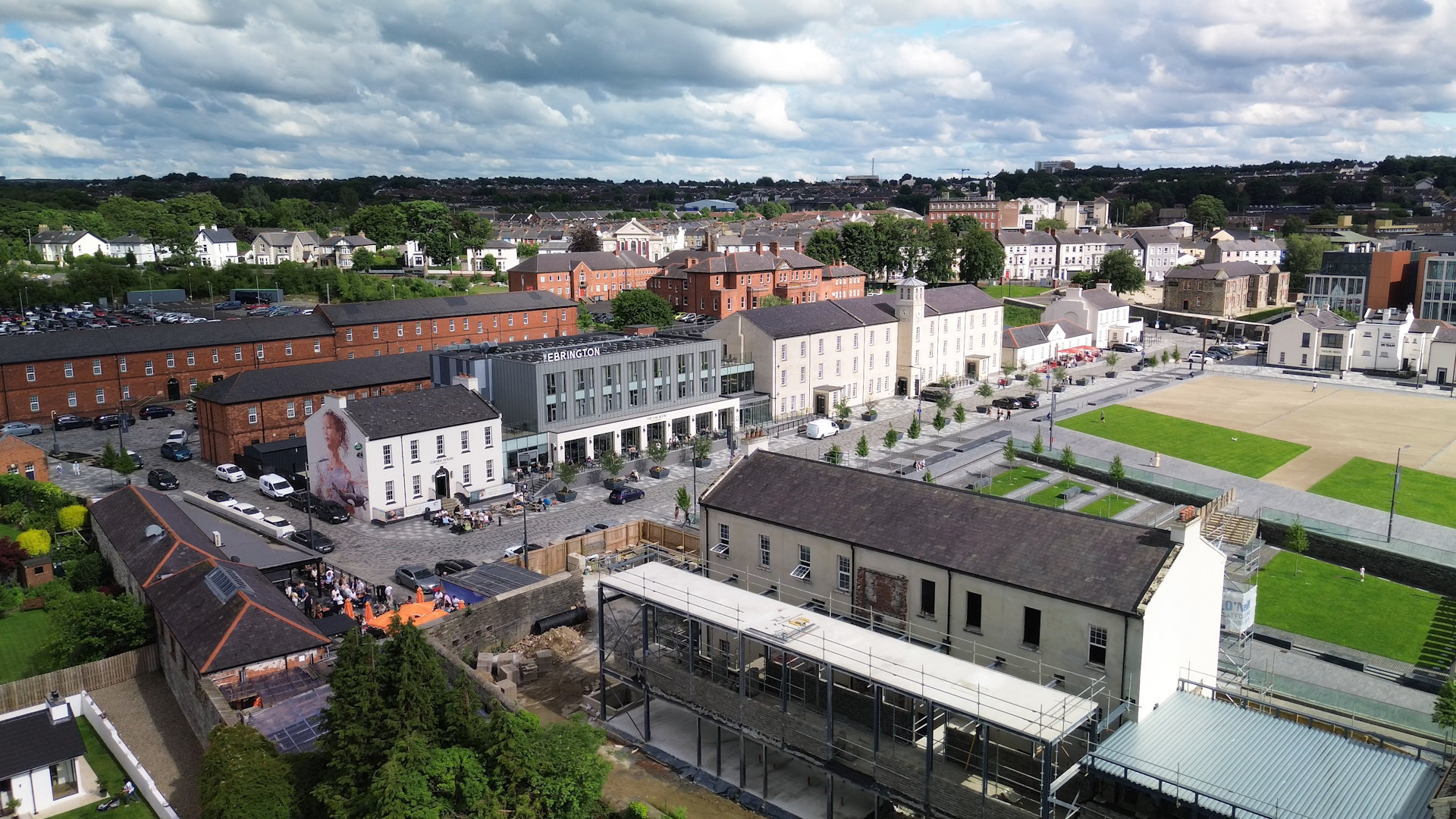 High-angle drone perspective showcasing Ebrington Square and the Ebrington Hotel in Derry.