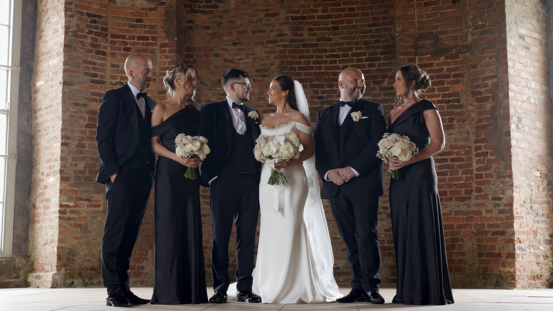 Bridal party pose inside Mussenden Temple during Rachel and Cathír's wedding portrait session.