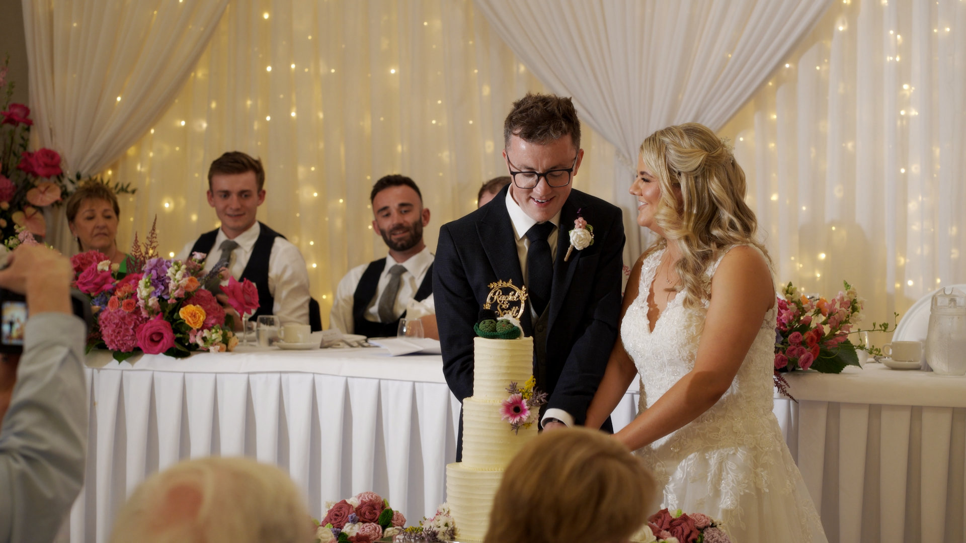 Bride Rachel and groom Scott cutting their wedding cake at Manor House Hotel reception