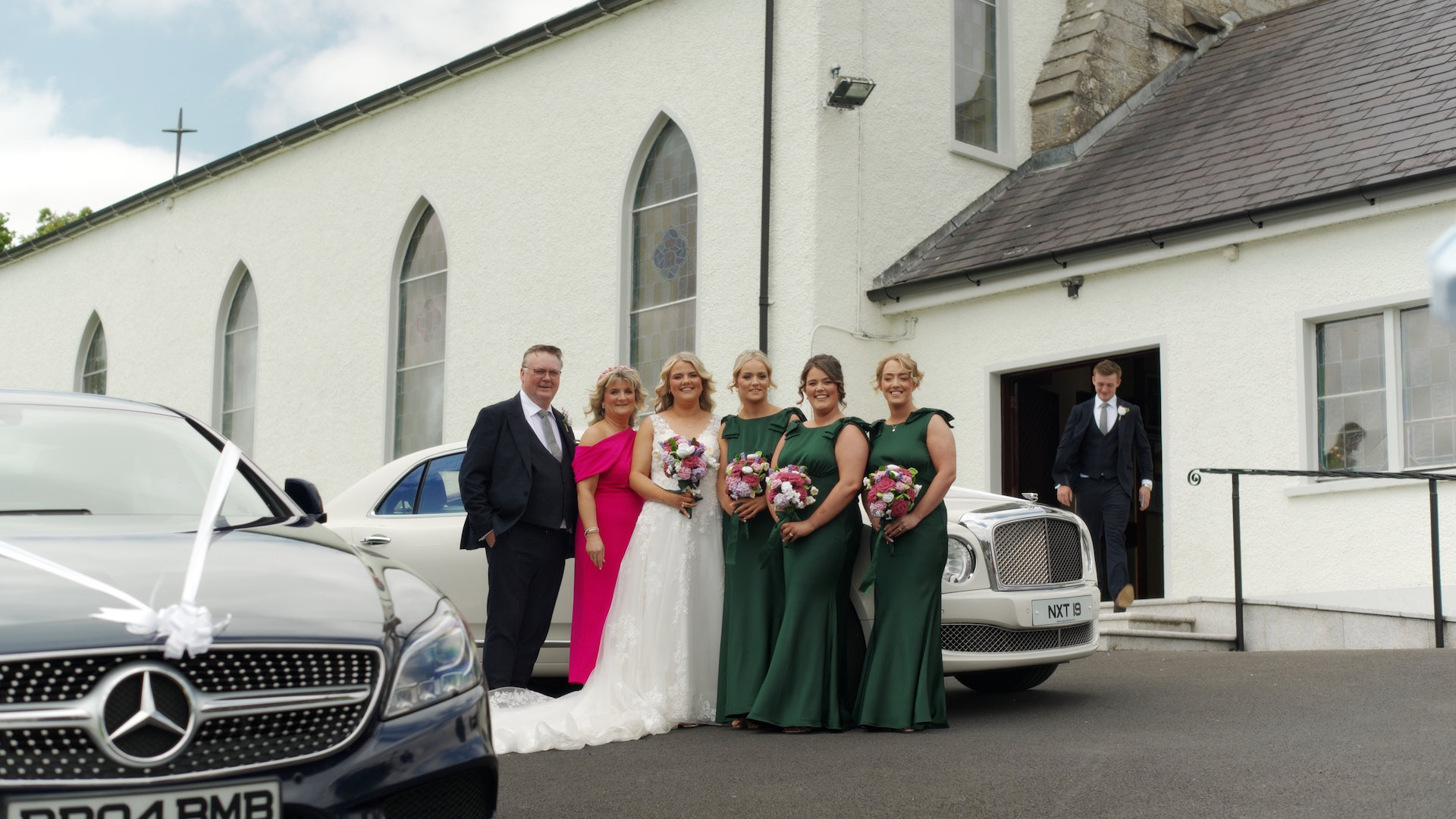 Bride Rachel with family and bridesmaids in green dresses outside St Mary's Church Pettigo